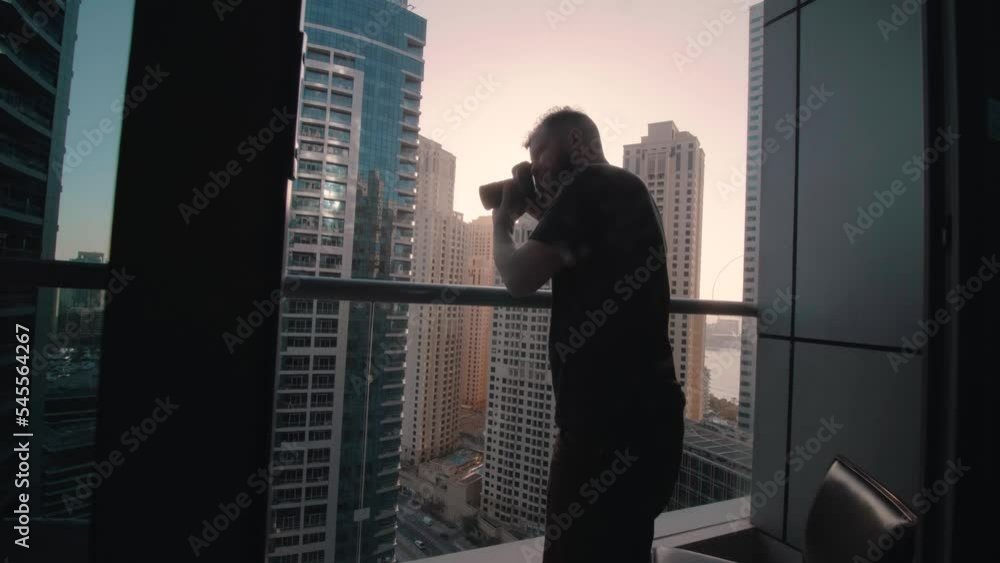Man photo of city view with camera on balcony at sunset 4K forward move slow motion Man photo of city view with camera on balcony at sunset 4K forward move slow motion
