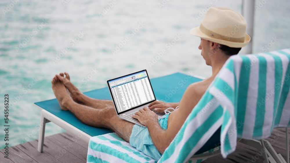 Man Using Spreadsheet Reports On Laptop Computer Man Using Spreadsheet Reports On Laptop Computer