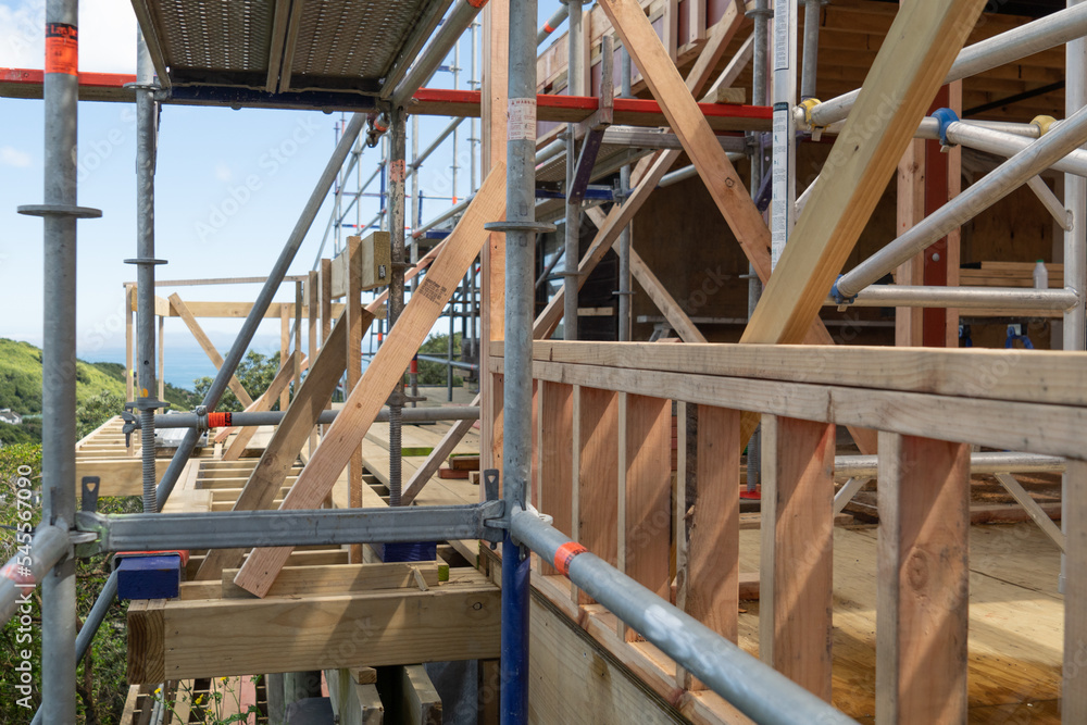 Metal scaffolding and wood building construction, building site Metal scaffolding and wood building construction, building site