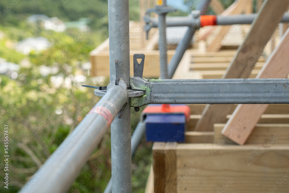 Metal scaffolding and wood building construction, building site Metal scaffolding and wood building construction, building site