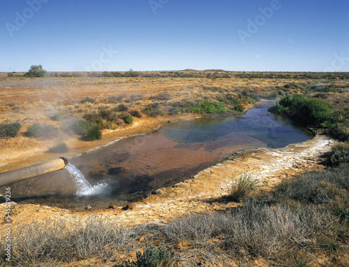 Hot water pouring from Arterian Bore on the Birdsville track. South Australia.