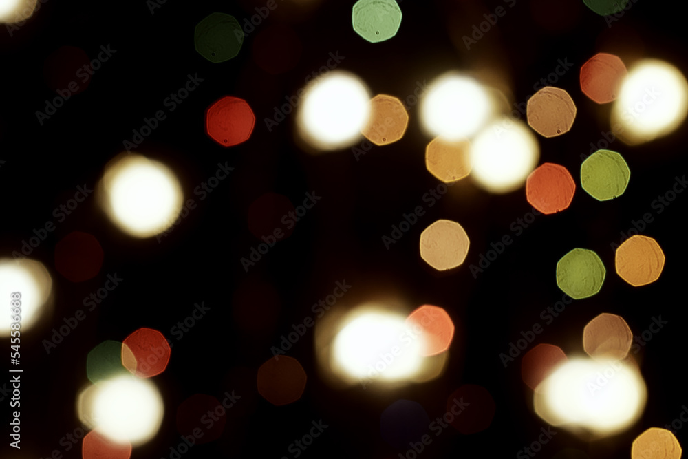 Fototapeta premium multicolored festive lights on a black background screensaver backdrop