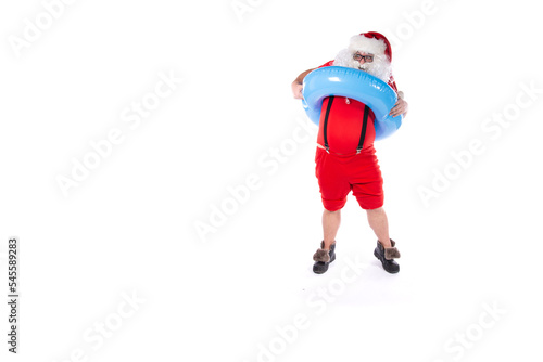 Vacation and holidays. Funny Santa Claus posing with an inflatable ring on a white background. Merry Christmas.