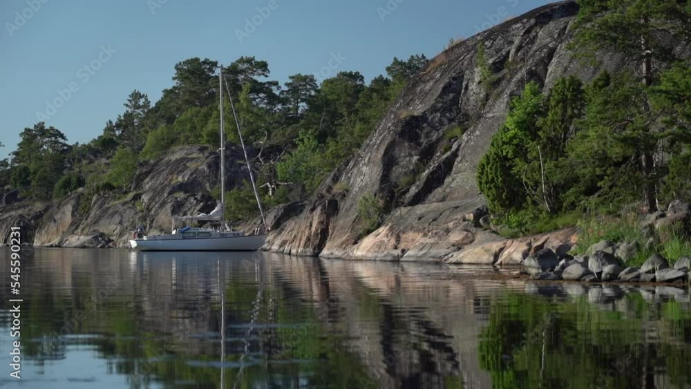 Sailboat anchored near remote rocky island in Stockholm archipelago, Sweden Sailboat anchored near remote rocky island in Stockholm archipelago, Sweden