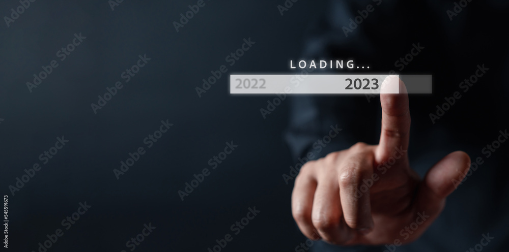 Businessman touching to virtual download bar and loading for New Year and changing year 2022 to 2023. start up planing business in next years concept... Businessman touching to virtual download bar and loading for New Year and changing year 2022 to 2023. start up planing business in next years concept...