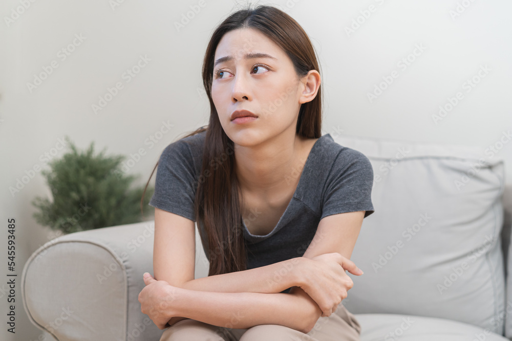 Mental health, depressed sad asian young woman, girl sitting on sofa, couch, expression to face difficulty, failure and exhausted. Thoughtful worried suffering depression feeling lonely, alone at home Mental health, depressed sad asian young woman, girl sitting on sofa, couch, expression to face difficulty, failure and exhausted. Thoughtful worried suffering depression feeling lonely, alone at home