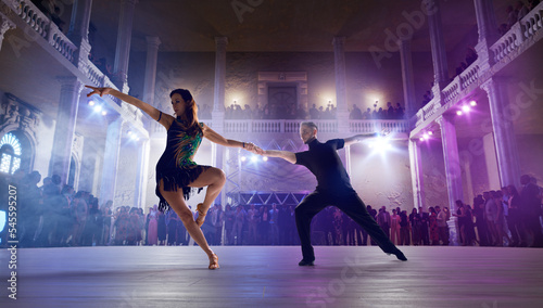 Couple dancers perform latin dance on large professional stage. Ballroom dancing. © VIAR PRO studio