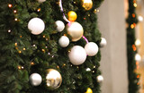 Christmas green tree with white balls Decorations on the street with blurred background with bokeh