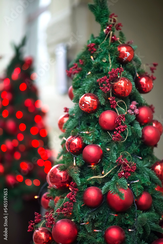 Christmas green tree with red balls Decorations on the street with blurred background with bokeh
