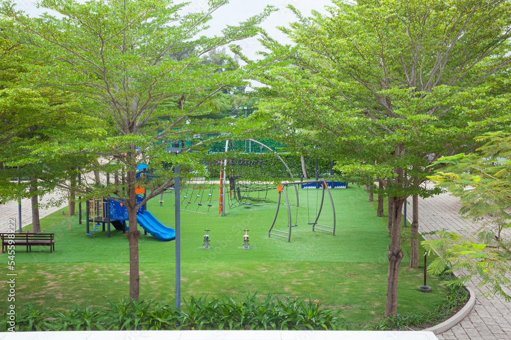 High angle view of children colorful playground on green grass in the park