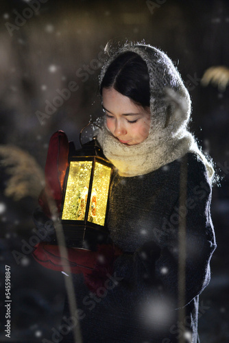 A girl at night in the snow goes in search of a miracle with a lantern.