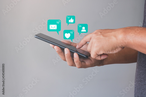 Social media and digital online concept, Man hand using smartphone and show technology icon social media. Concept social network. living on vacation, Social Distancing, Working From Home concept.