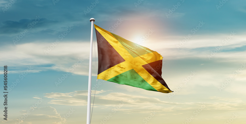 Jamaica national flag cloth fabric waving on the sky - Image
