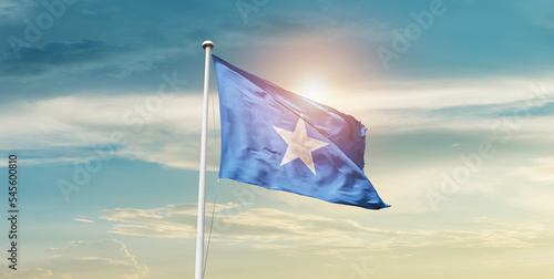 Somalia national flag cloth fabric waving on the sky - Image