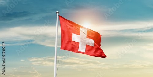 Switzerland national flag cloth fabric waving on the sky - Image photo