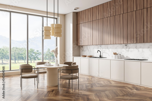 Stylish kitchen interior with eating and cooking corner  kitchenware and window