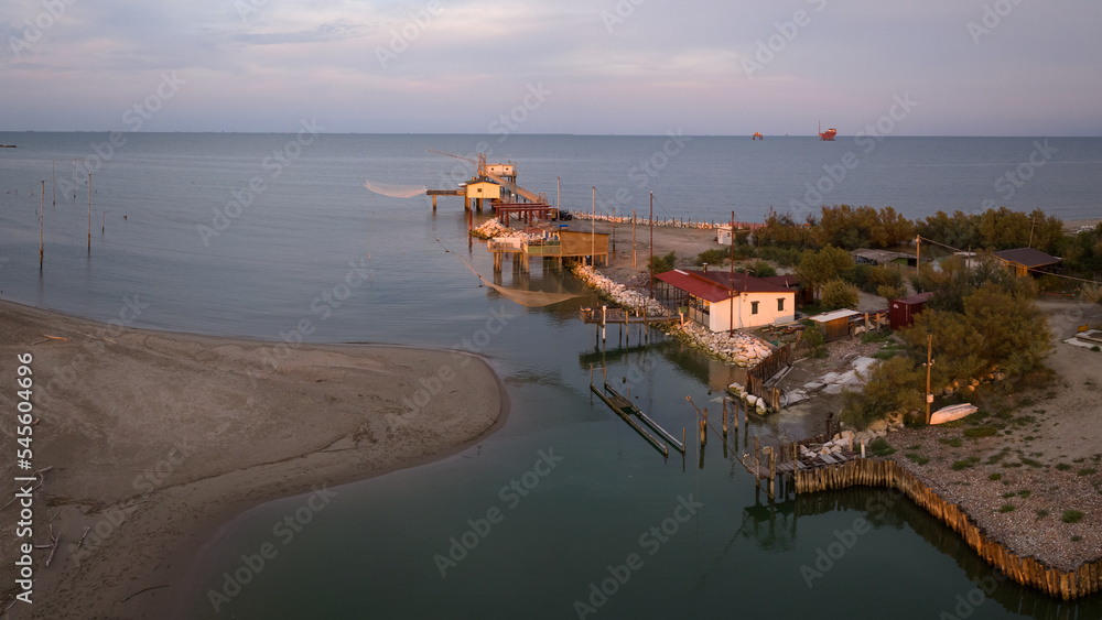 Aerial view of fishing huts on shores of estuary at sunset,italian fishing machine, called 