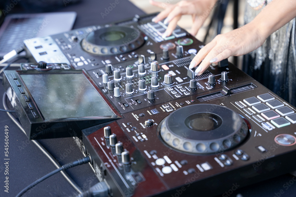 Hands of a female dj using a digital mixer. Hands of a female dj using a digital mixer.
