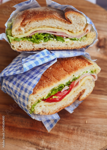 Italian ciabatta bread sandwich with rucola , tomatoes and  prosciutto  crudo