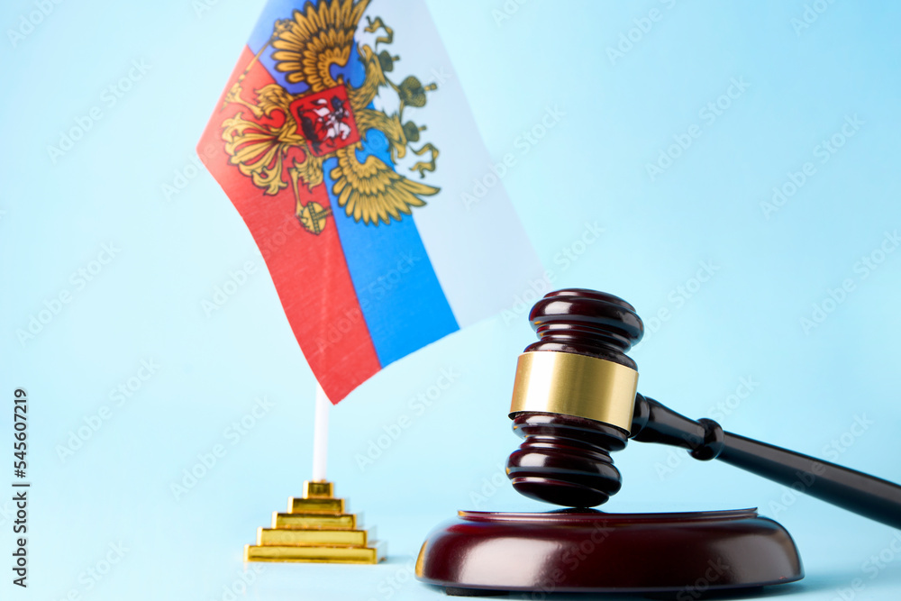 Judge Gavel and Flag Of Russia on blue background