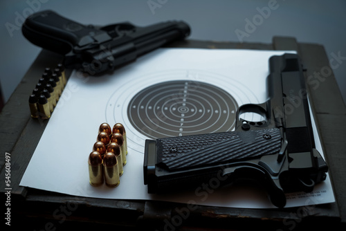 Handguns, ammo and target , m1911 and b85fs. 