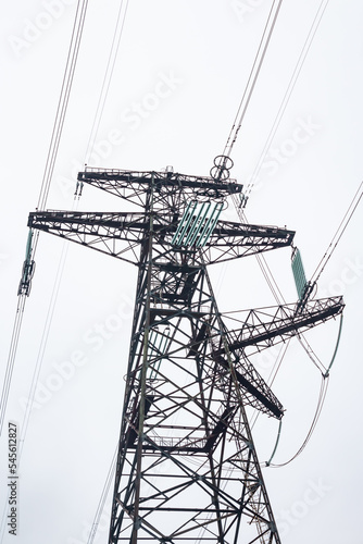 Metal support with high voltage insulators against the sky in the autumn. Energy industry. Production, distribution and transmission of electricity. power lines. Power substation.