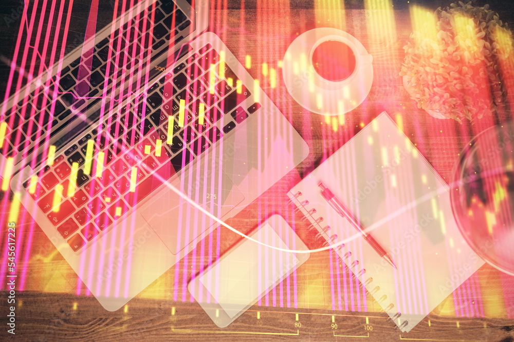 Obraz premium Financial market graph and top view computer on the desktop background. Double exposure. Investment concept.
