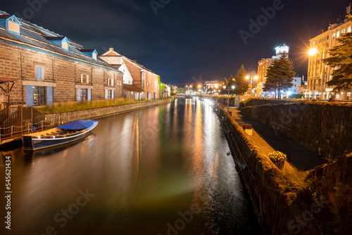 Boats floating on illuminated canals