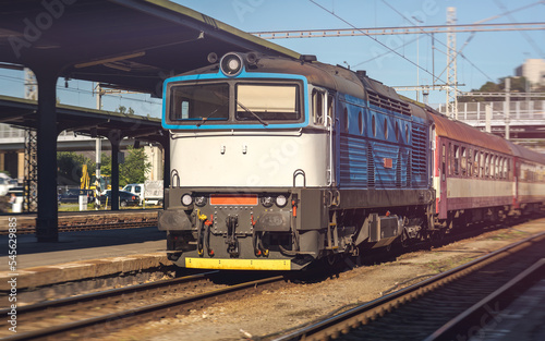 An Older Type Passenger Train Arriving at a Station of Industrial Construction, European Train Connections