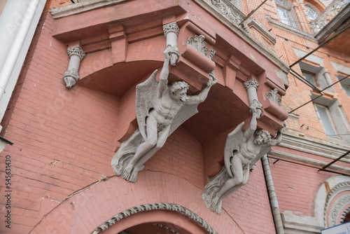 Lions holding the balcony of a historic baroque building. photo