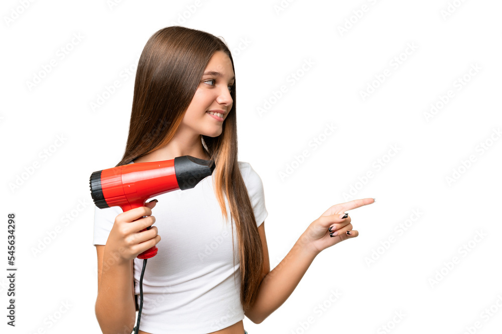 Teenager Caucasian girl holding a hairdryer over isolated background pointing to the side to present a product Teenager Caucasian girl holding a hairdryer over isolated background pointing to the side to present a product