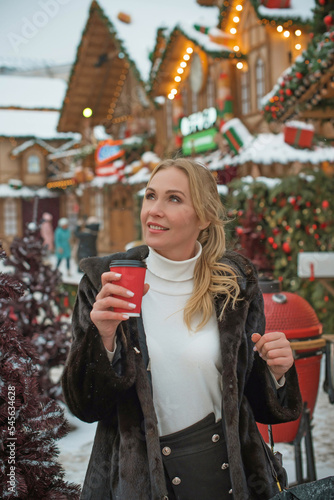 Christmas fair, Holidays magical vibe, winter's day with a snow, tourist lady at Europe