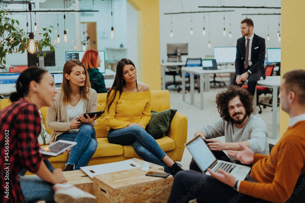 Multiethnic group of employees working in a marketing company. A group of colleagues is working on a project in modern offices Multiethnic group of employees working in a marketing company. A group of colleagues is working on a project in modern offices
