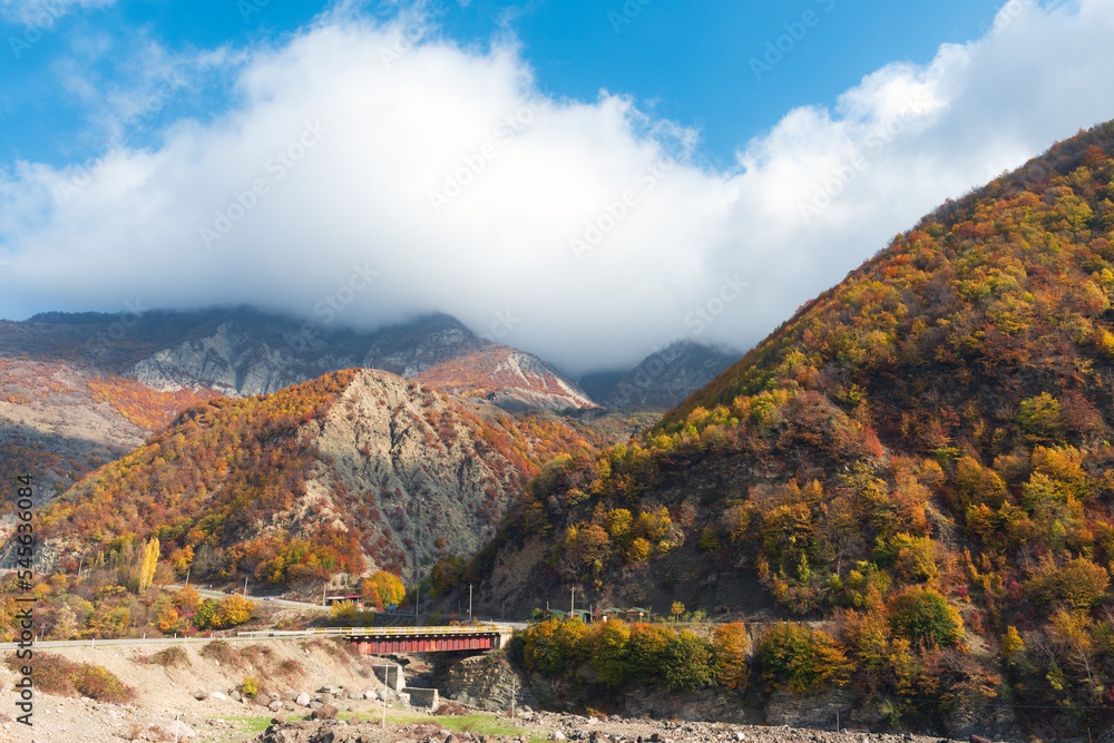 Bridge over mountain river in autumn time