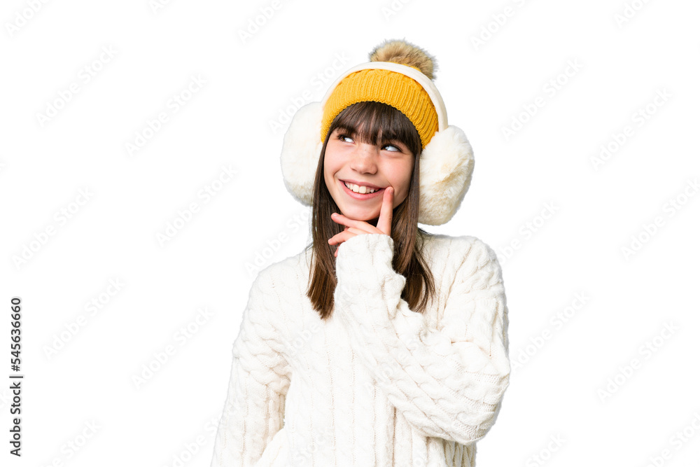 Little caucasian girl wearing winter muffs over isolated background thinking an idea while looking up Little caucasian girl wearing winter muffs over isolated background thinking an idea while looking up