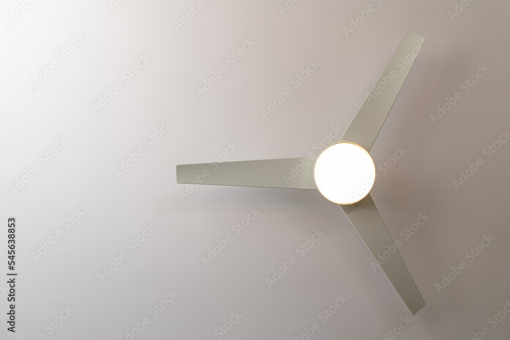 Isolated white ceiling fan with light turned on, view from below Isolated white ceiling fan with light turned on, view from below