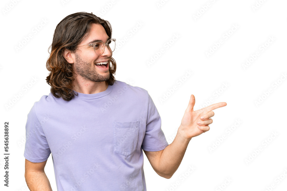 Young handsome man over isolated background pointing finger to the side and presenting a product