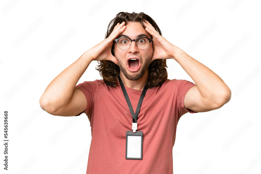 Young handsome man with ID card over isolated background with surprise expression Young handsome man with ID card over isolated background with surprise expression