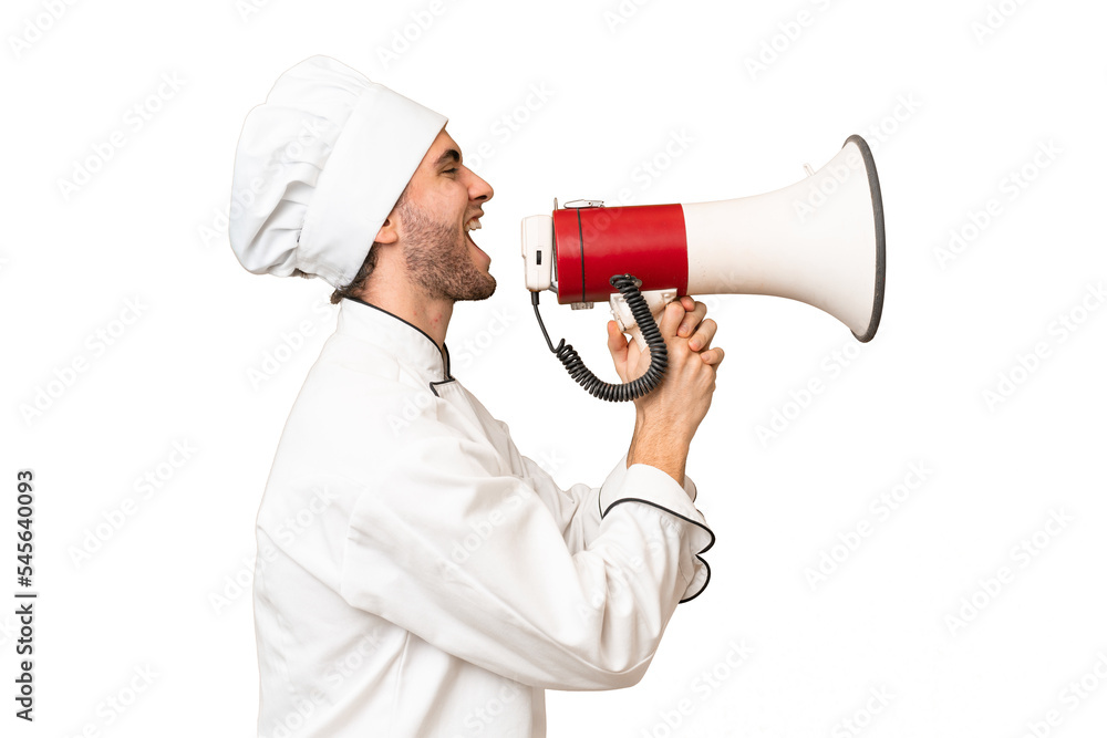 Young handsome chef man over isolated background shouting through a megaphone