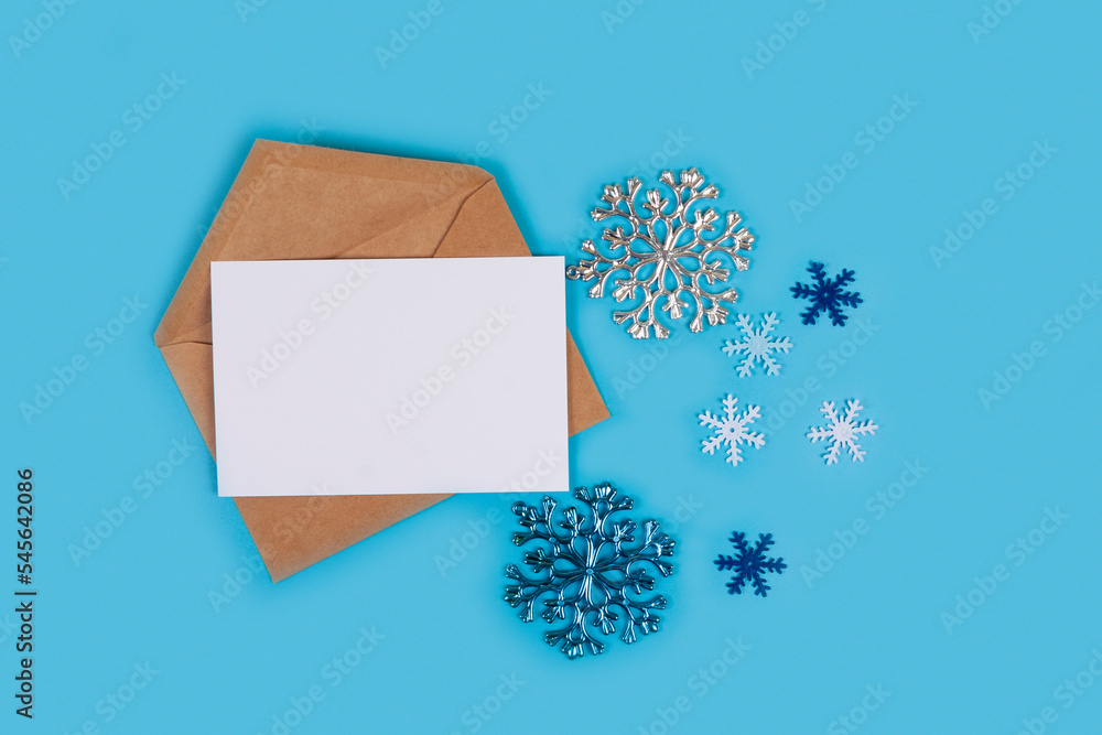 Christmas composition. Christmas decorations and envelope on blue background. Christmas composition. Christmas decorations and envelope on blue background.
