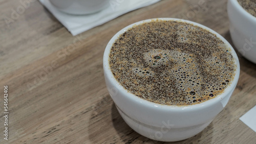 coffee cupping, pour 150 grams of hot water into cup.
Scent to the aromas of the wet coffee.  take note of what you smell.