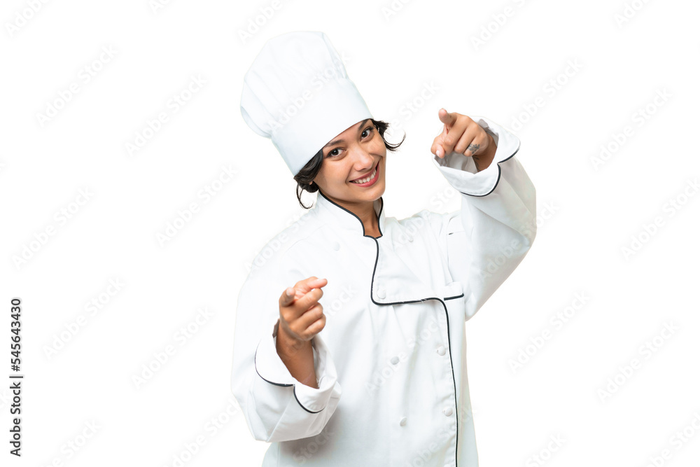 Young chef Argentinian woman over isolated background points finger at you while smiling