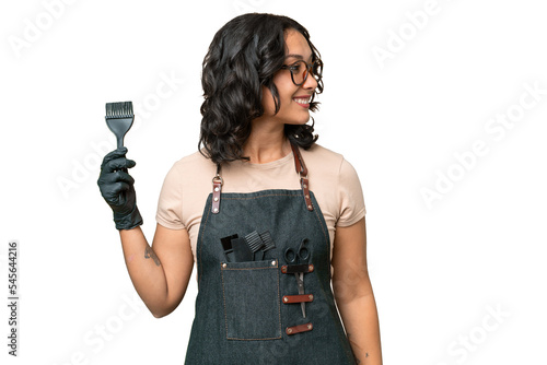 Young argentinian hairdresser woman over isolated background looking to the side and smiling