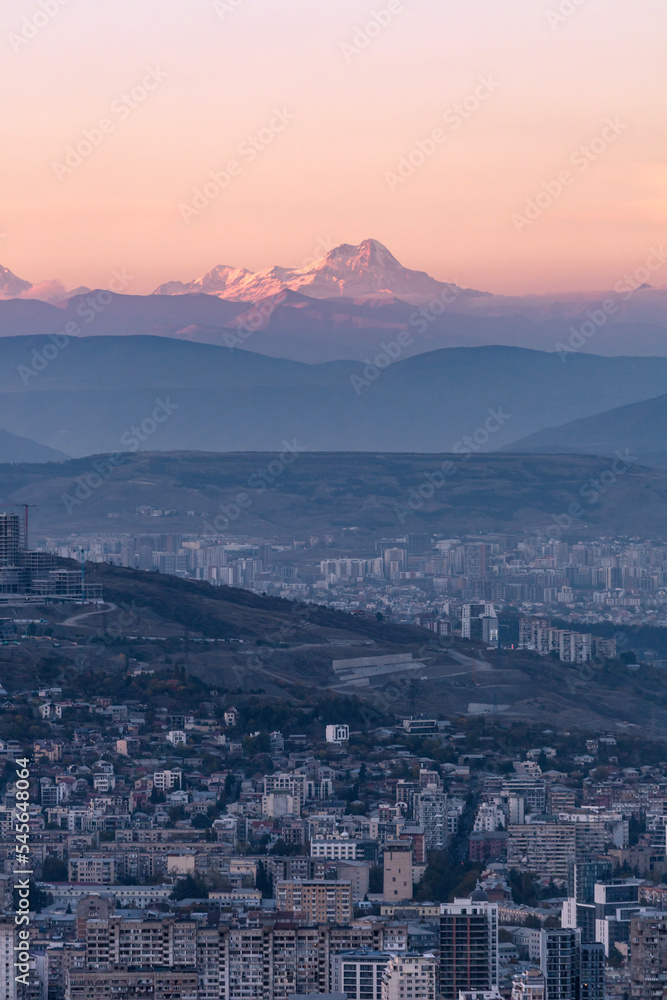 top view of tbilisi at dusk and the top of Mount Kazbek on the horizon