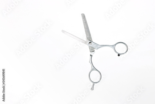 Professional flying scissors for haircuts on white background. Hairdresser scissors on white background with copy space for text.