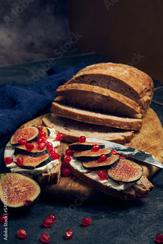 slices of rye bread with figs and pomegranate