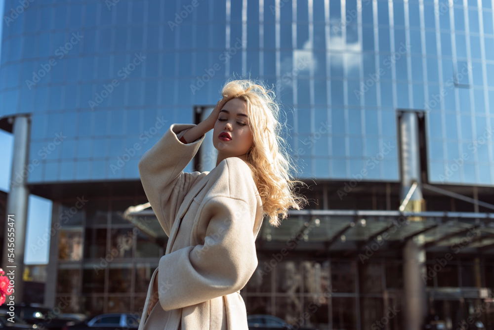 Fototapeta premium Young blonde woman in autumn city