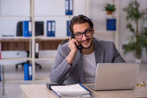 Young male employee working in the office