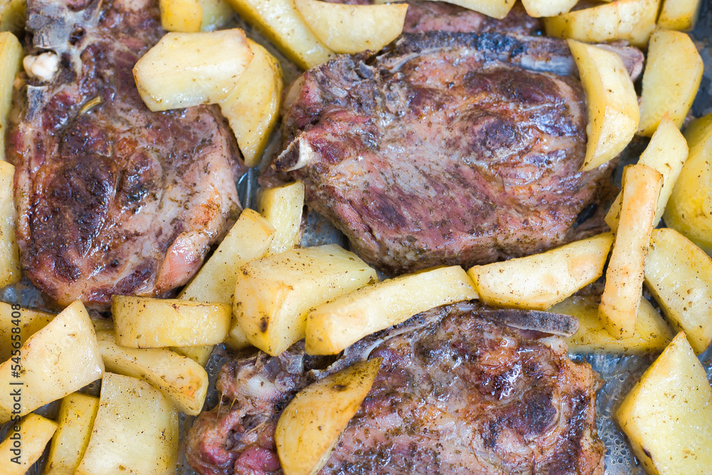 homemade food, steaks with potatoes in the oven homemade food, steaks with potatoes in the oven