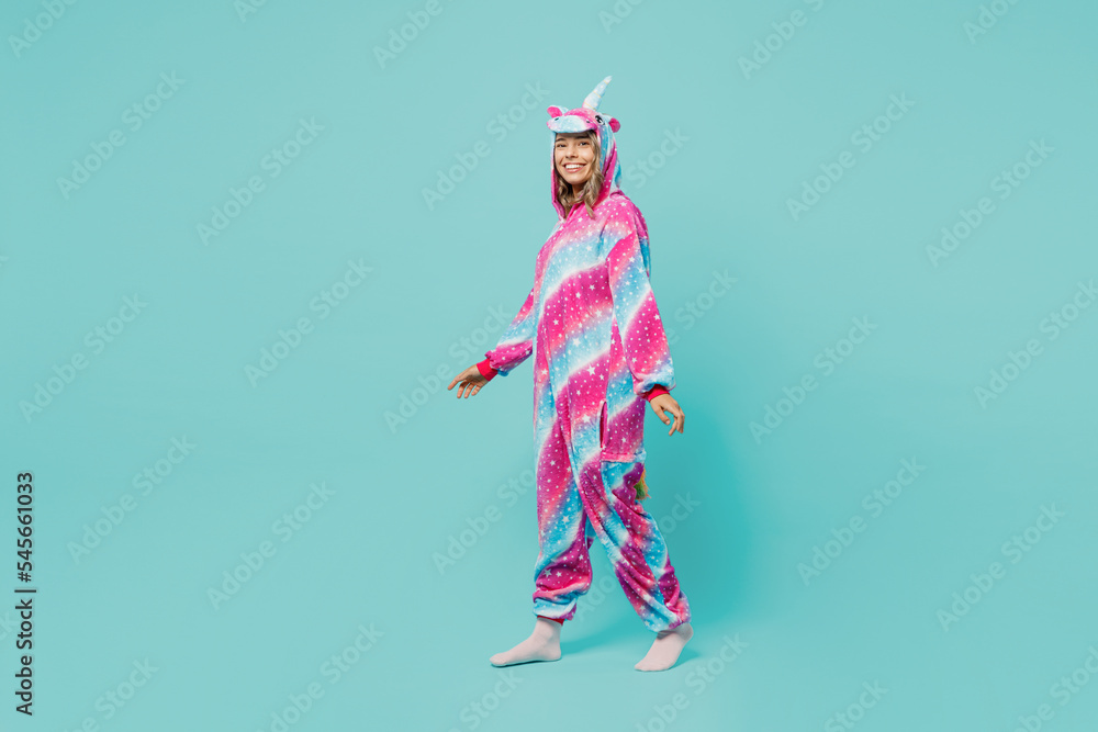 Full body young smiling happy woman 20s she wear domestic costume with hoody and animals ears walking going look camera isolated on plain pastel light blue cyan background. People lifestyle concept.